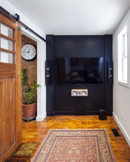 Industrial Home Theater by Wanda Ely Architect Inc.